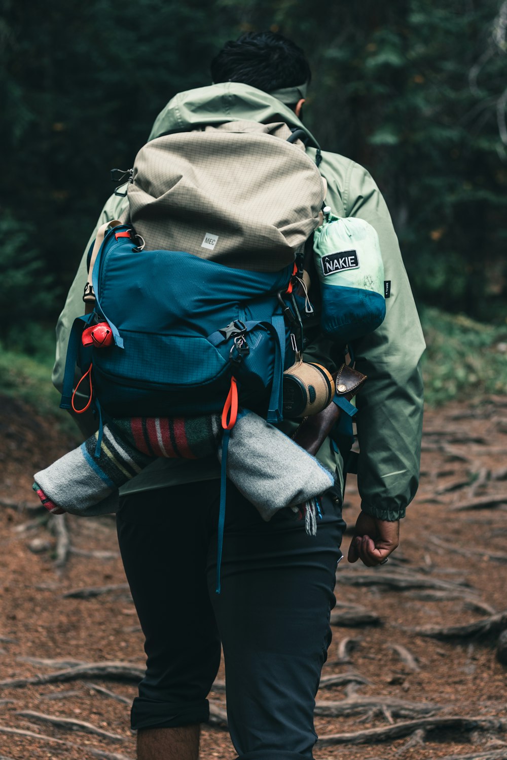 a person with a backpack walking through the woods