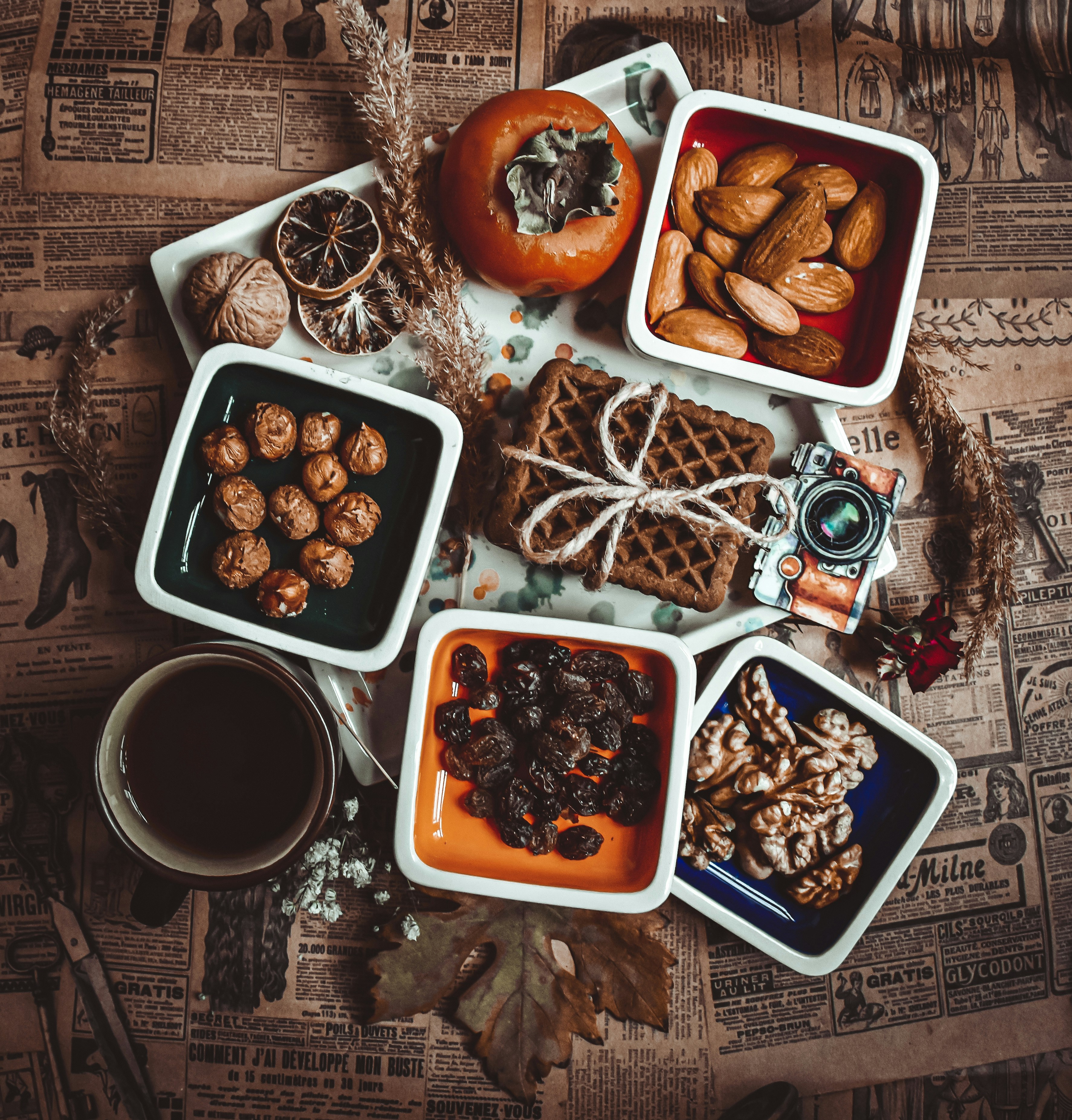 a table topped with trays of food next to a cup of coffee- thanksgiving family activities related to food