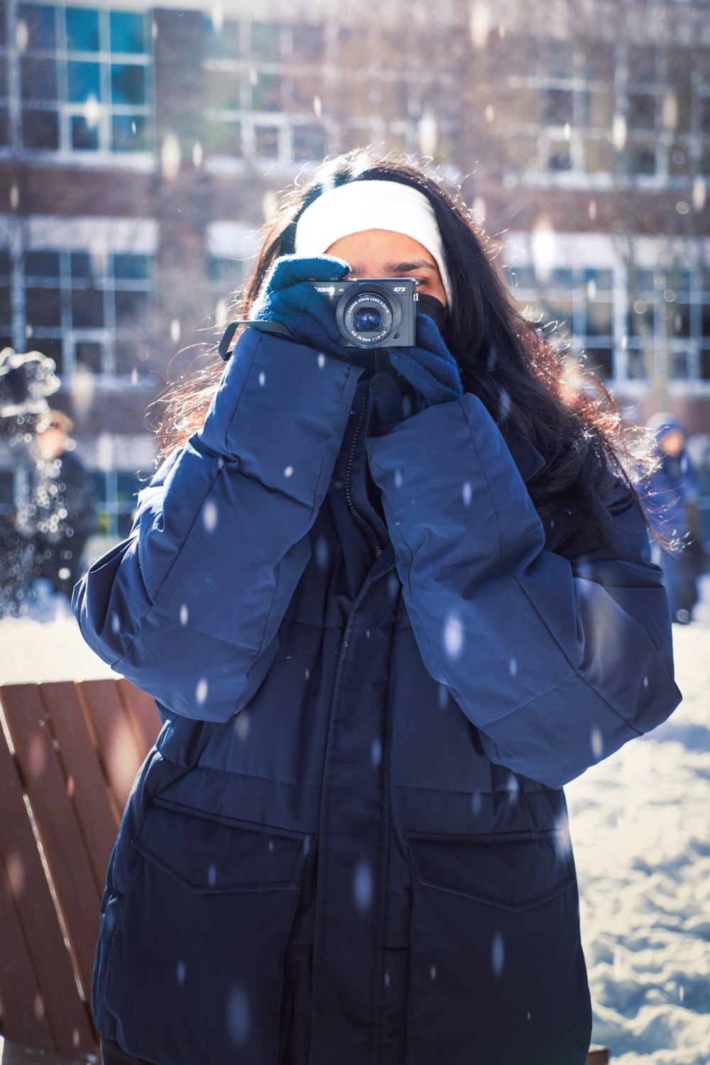 a woman taking a picture of herself in the snow