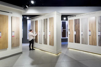 a man standing in front of a display of wooden doors