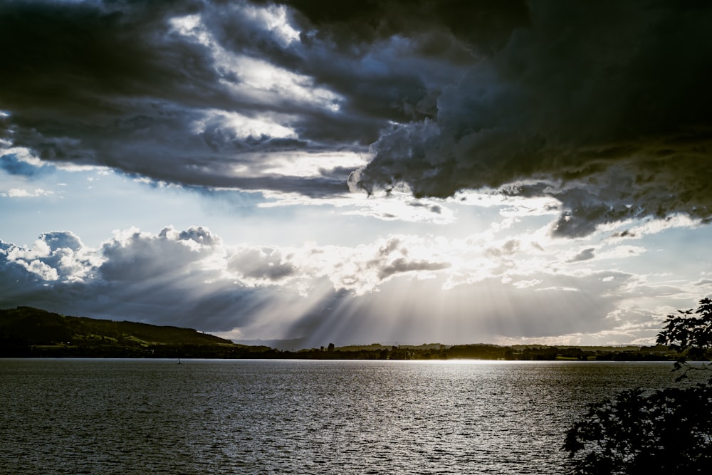 a large body of water under a cloudy sky