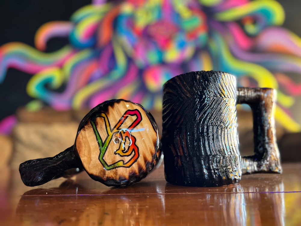 a couple of wooden mugs sitting on top of a wooden table