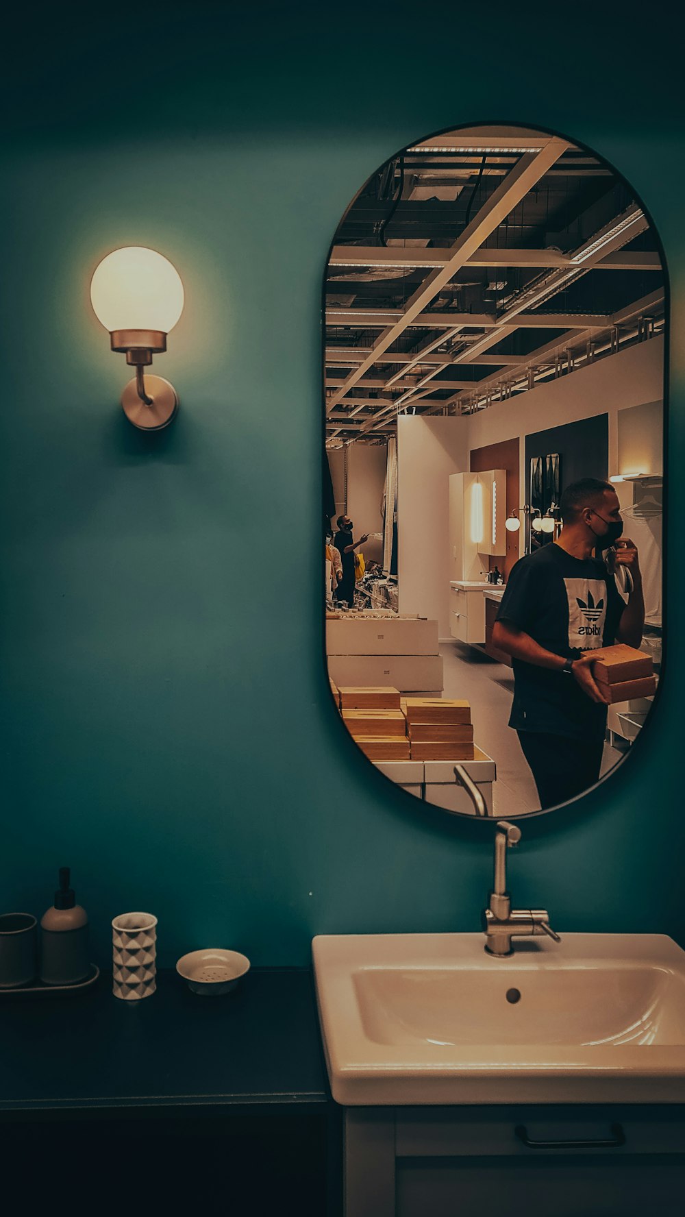 a man standing in front of a bathroom mirror