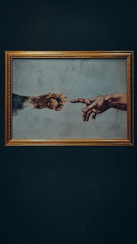a painting of two hands reaching out to touch each other