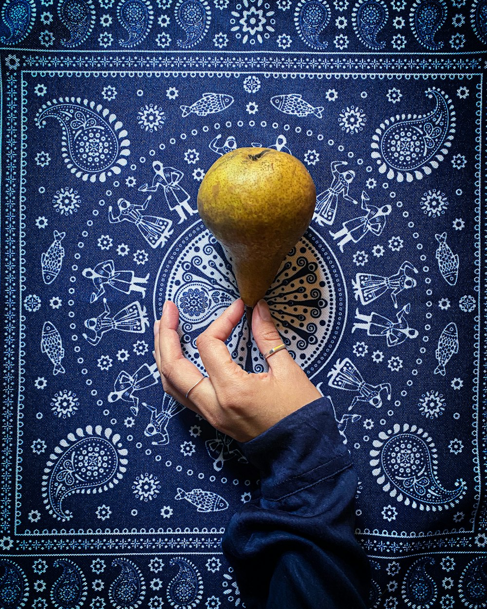 a person is holding a pomegranate in their hand
