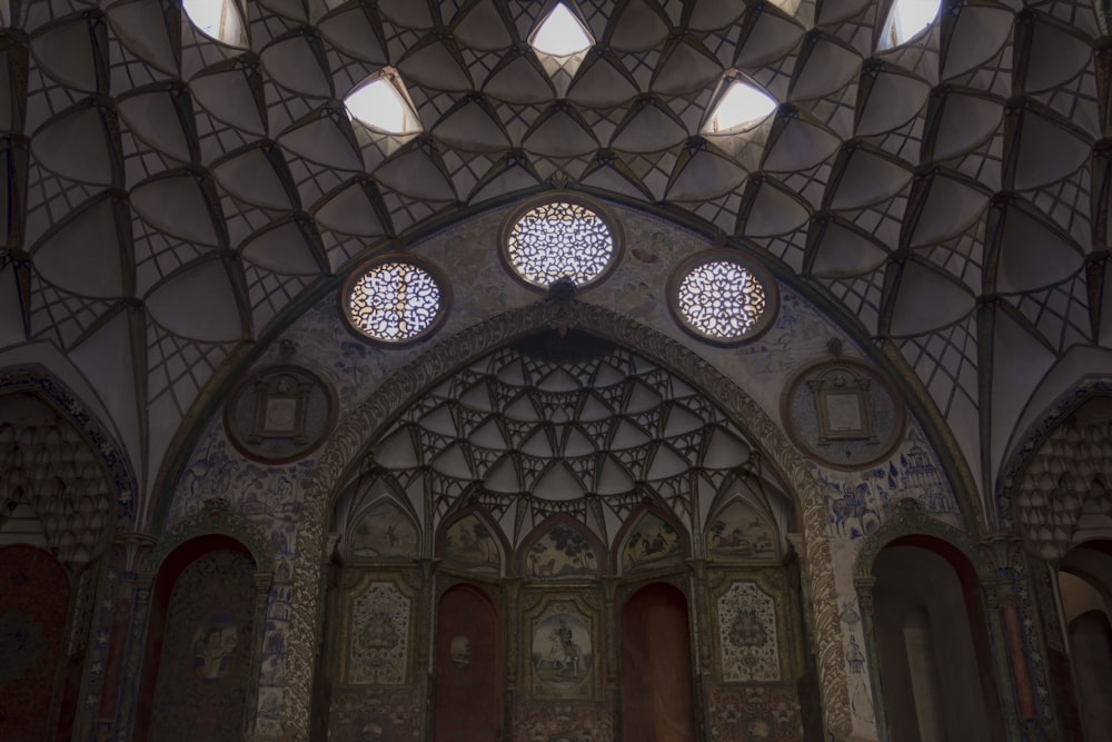 the ceiling of a building with many round windows