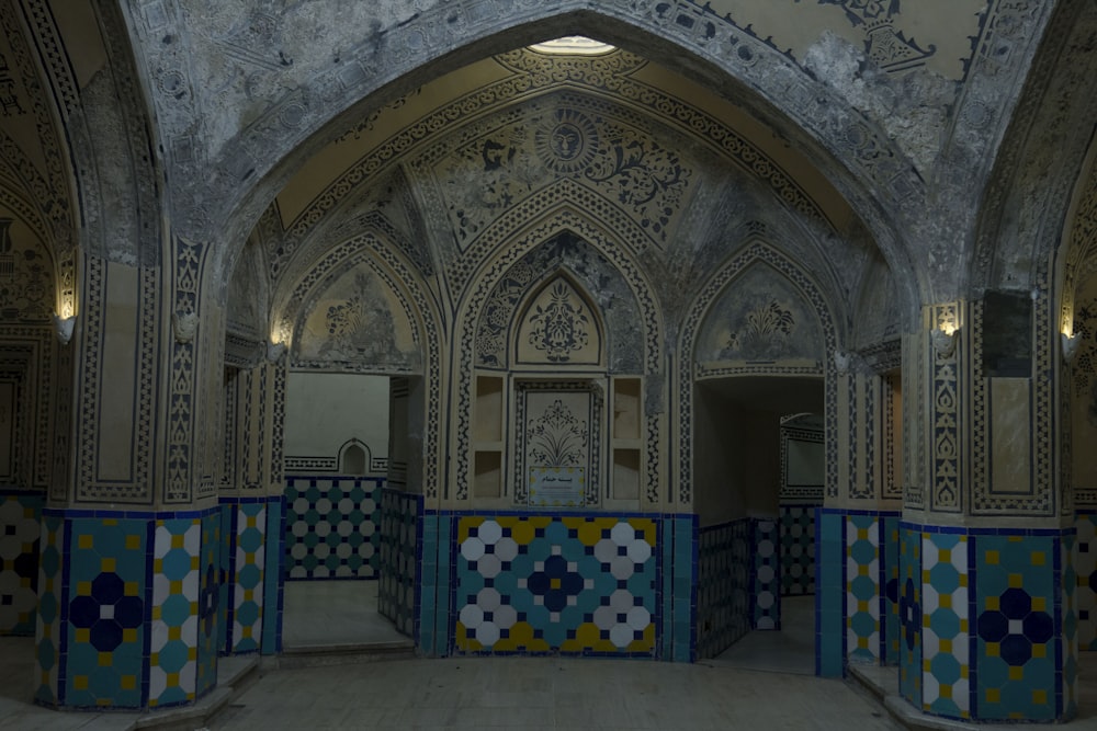 a room with blue and yellow tiles and walls