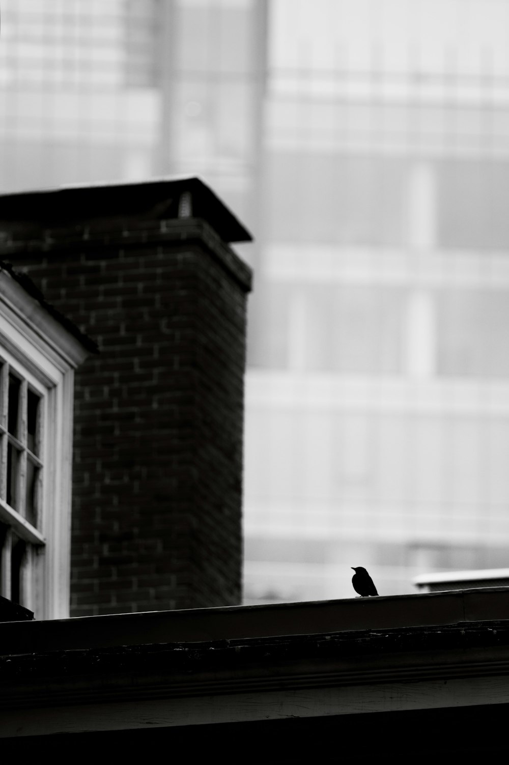 a tall brick building sitting next to a window