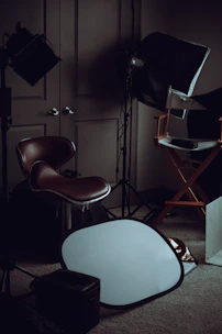 A sleek, dimly lit studio with a director’s chair and storyboard sketches pinned on a wall.