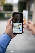 a person taking a picture of a cigarette with a cell phone