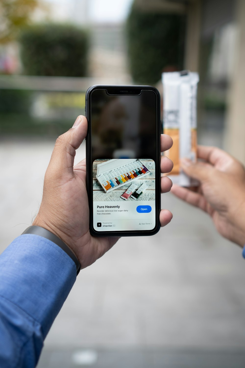 a person taking a picture of a cigarette with a cell phone