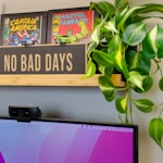 a flat screen tv sitting on top of a wooden shelf