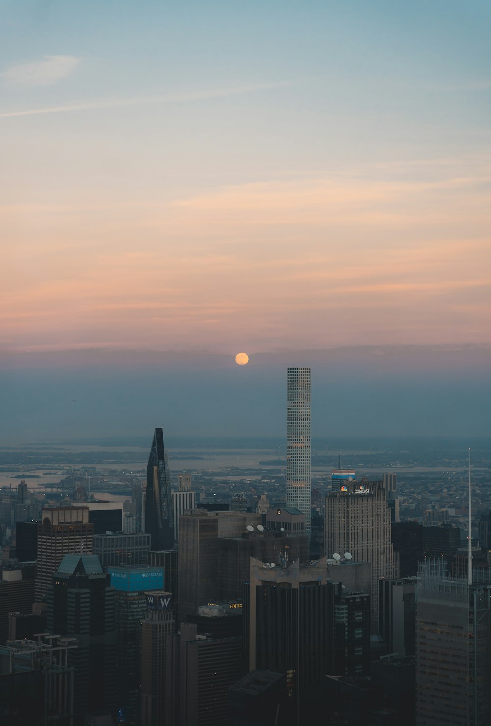 the sun is setting over a large city