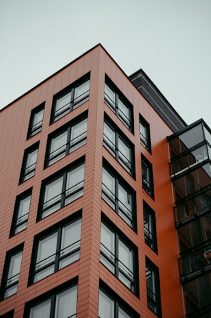 a tall red building with lots of windows