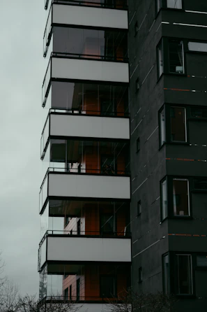Modern residential building with dark sleek design, reflecting sophistication.