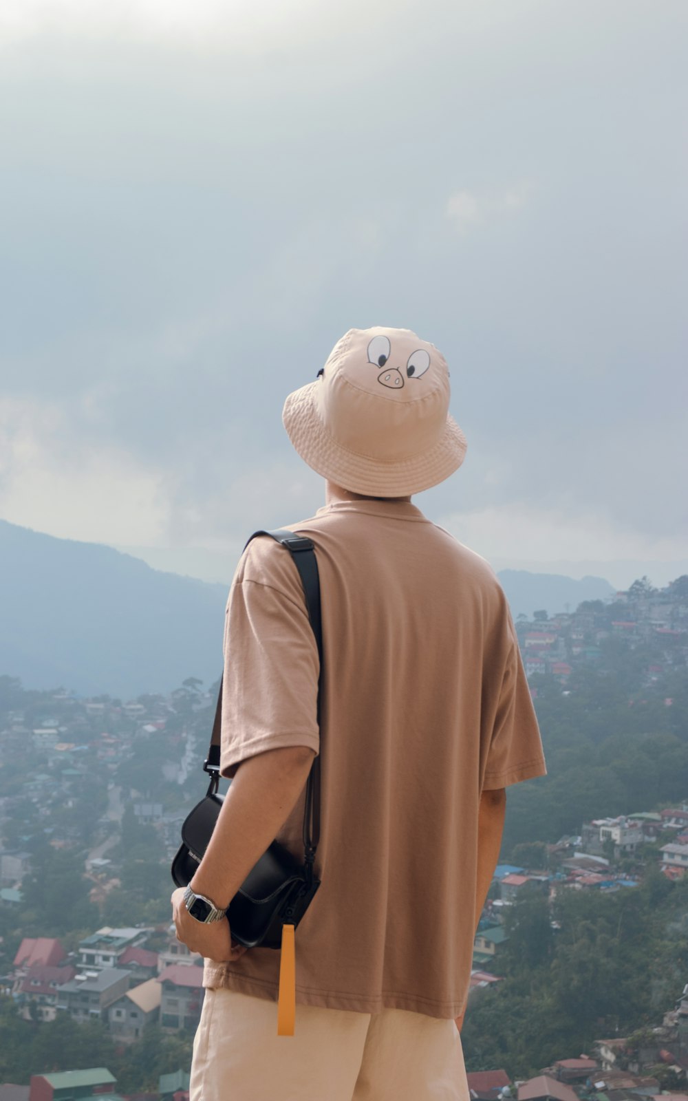 a man standing on top of a hill with a backpack