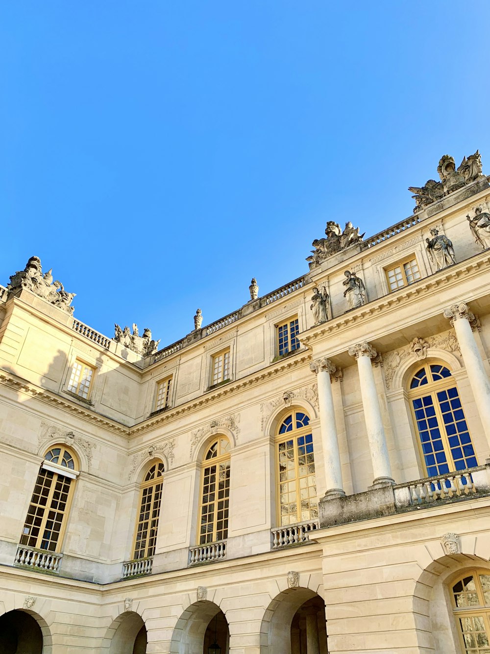 a large white building with a clock on the front of it