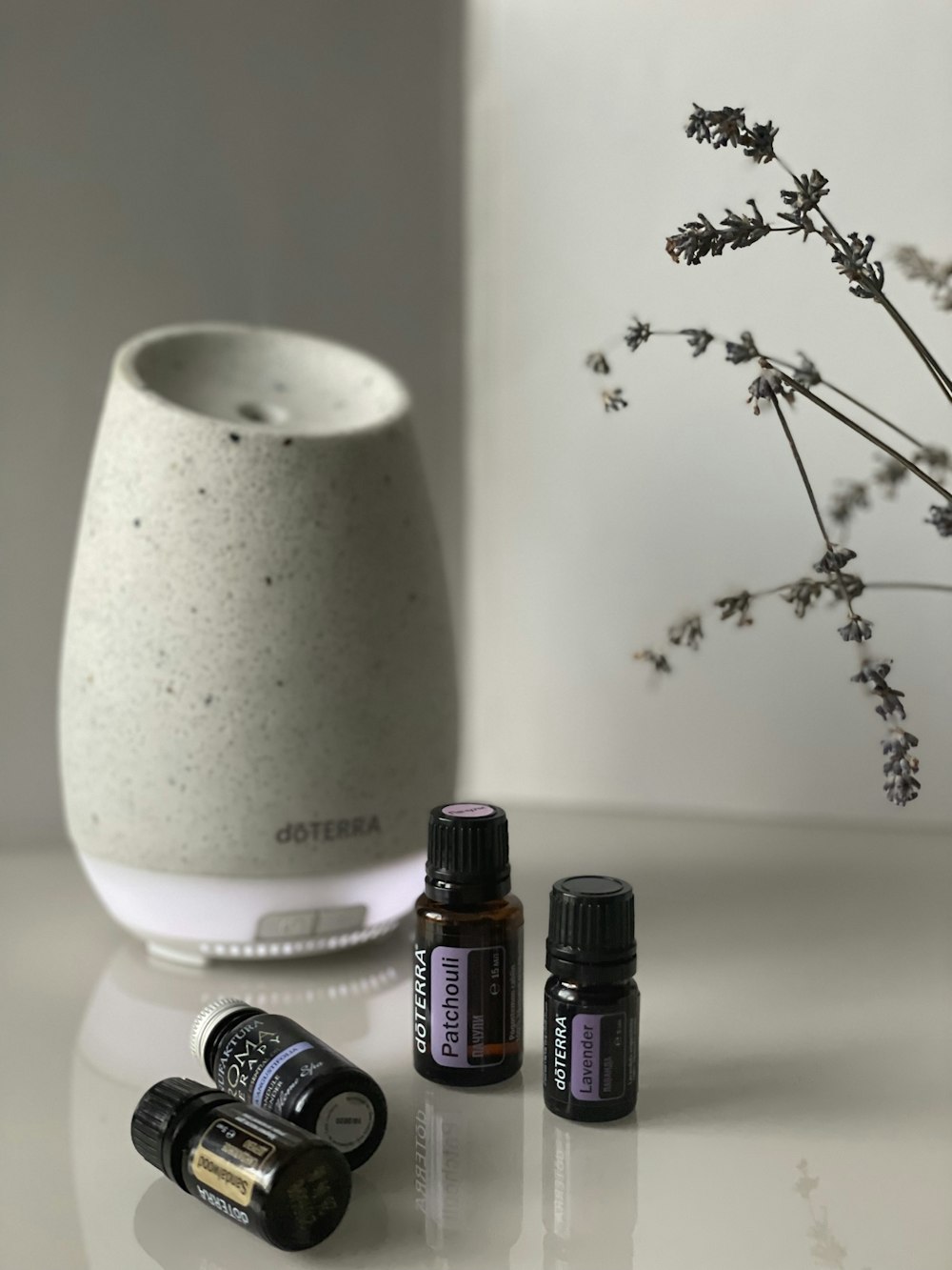 three bottles of essential oils sitting on a table