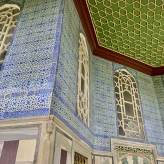 a room with blue and white tiles and a green ceiling