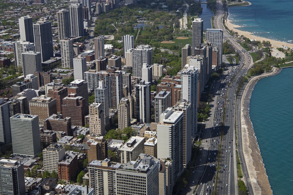 an aerial view of a large city next to a body of water