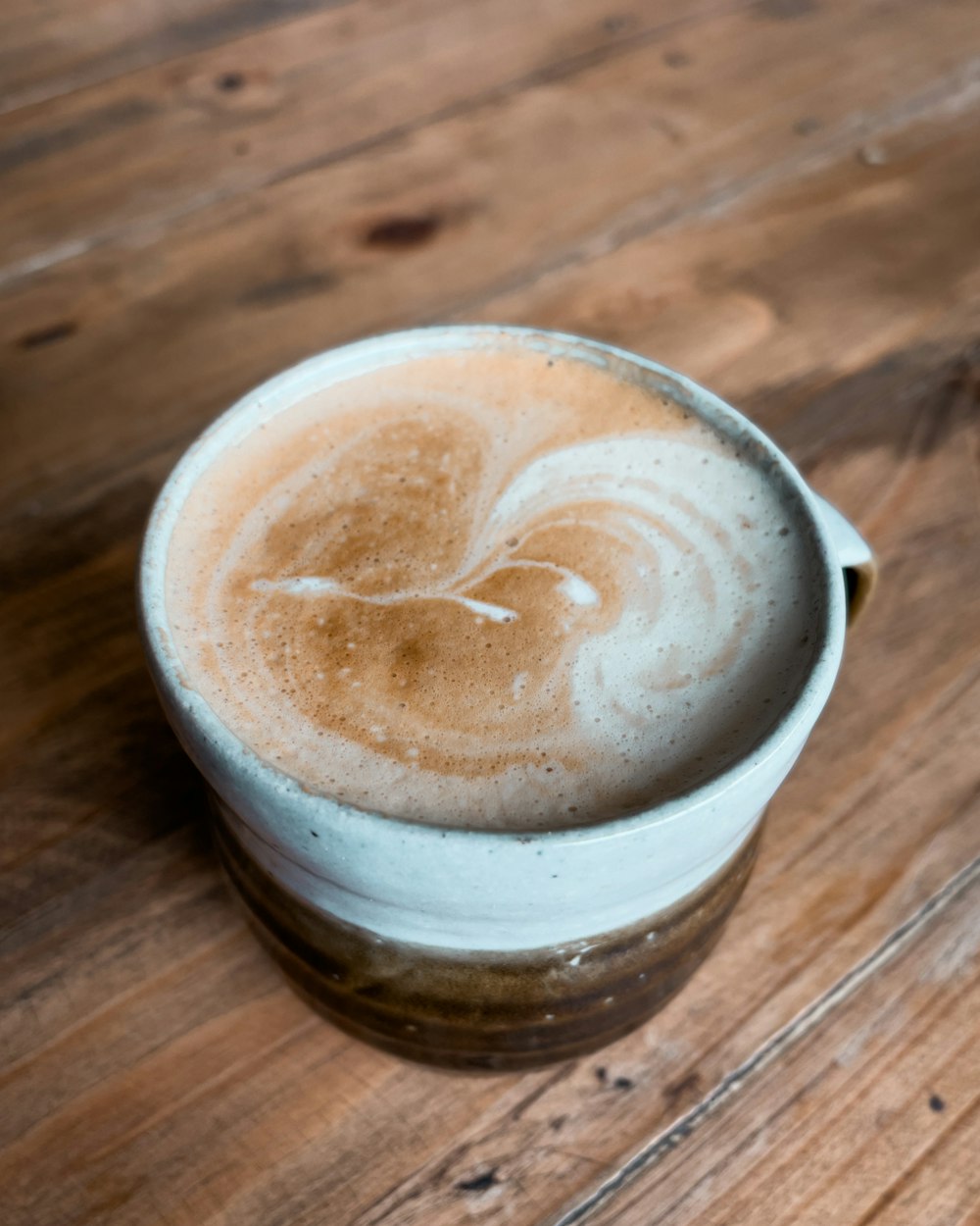 a close up of a cup of coffee on a table