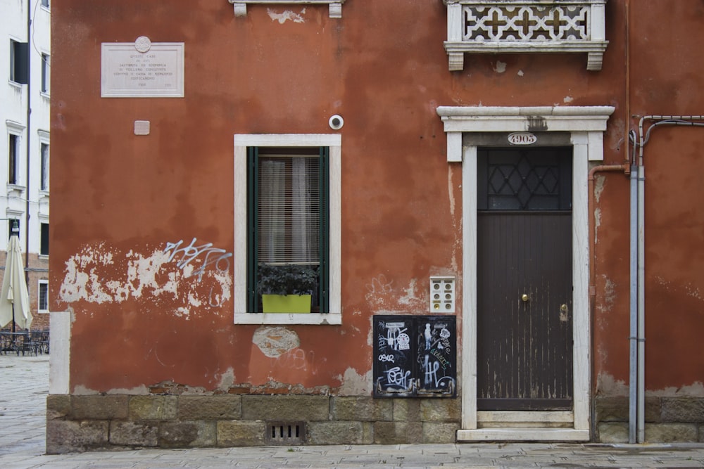 a red building with a black door and window