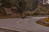 A scenic shot of a rider navigating a winding mountain road.