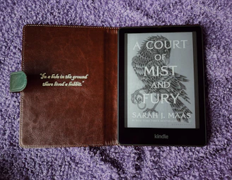 a book sitting on top of a purple blanket