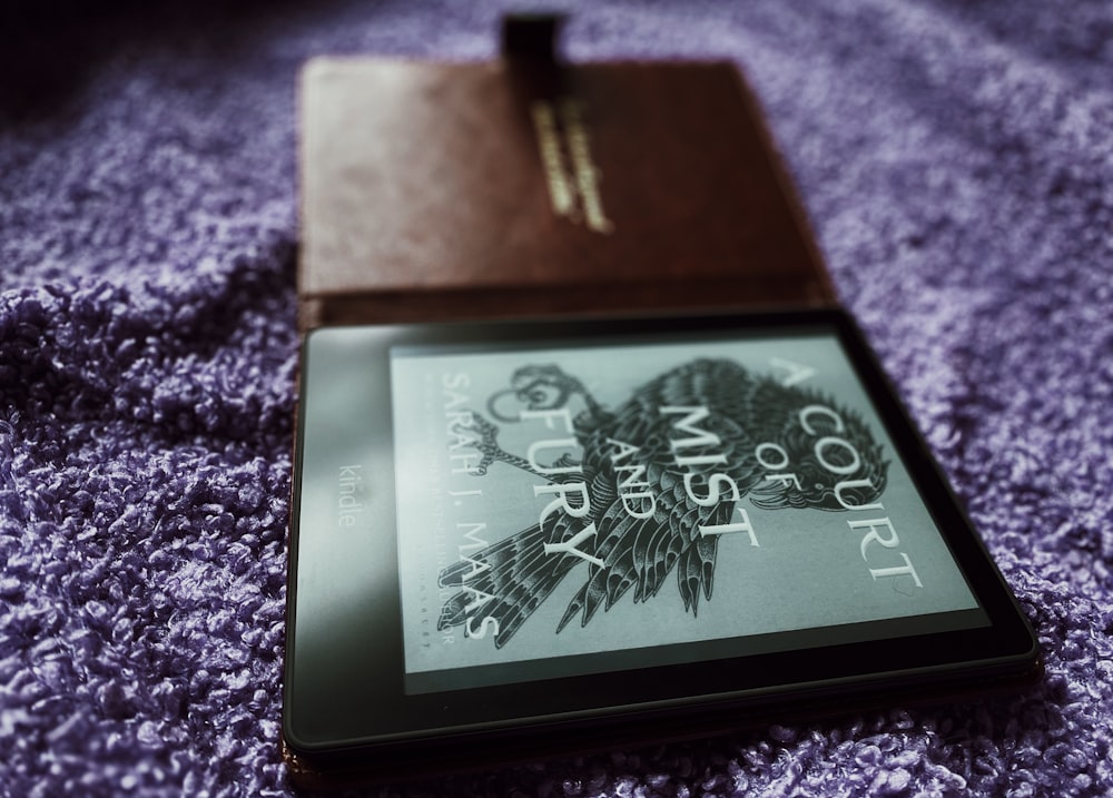 a book laying on top of a purple blanket