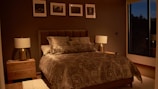 a bedroom with a large bed and a night stand
