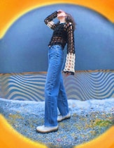 a woman standing in front of a blue wall