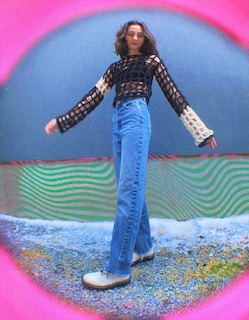 a woman standing in front of a colorful wall