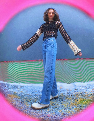 a woman standing in front of a colorful wall