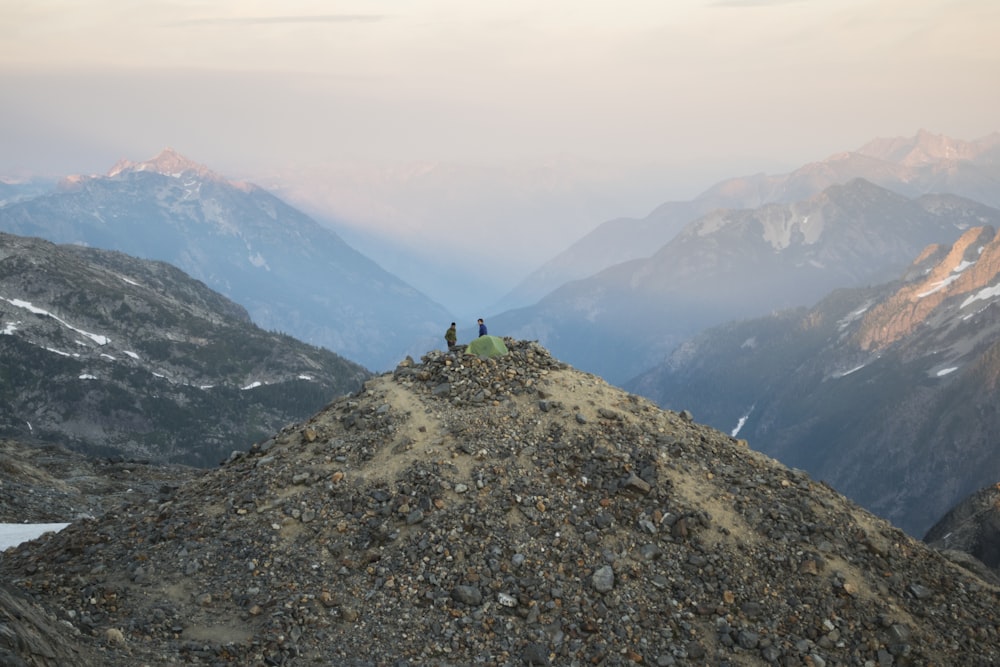 a group of people sitting on top of a mountain