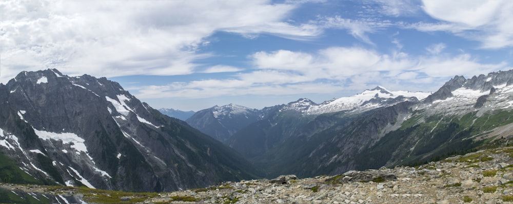 a man standing on top of a mountain with a backpack