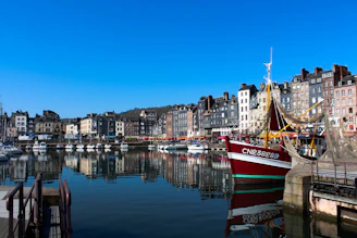 Honfleur a harbor filled with lots of boats next to tall buildings