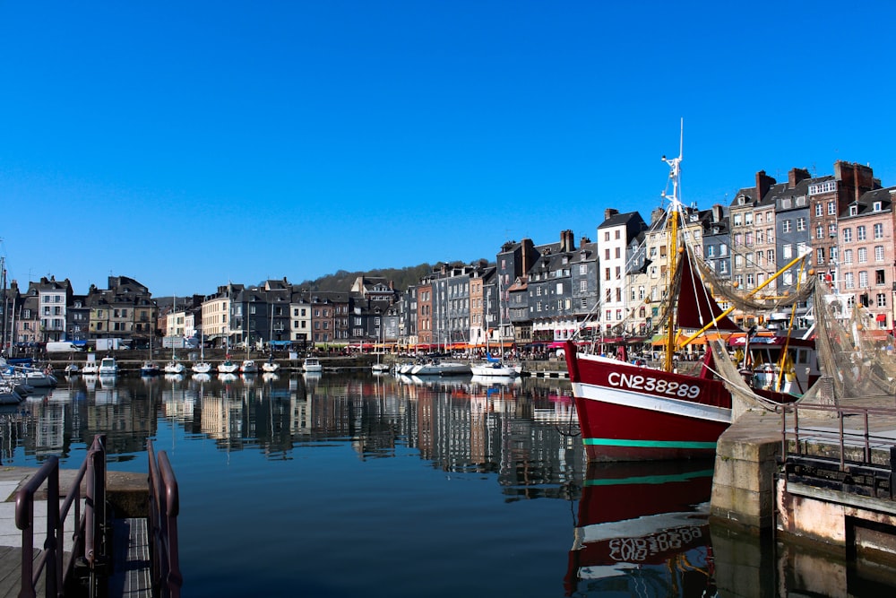 a harbor filled with lots of boats next to tall buildings