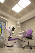 a dentist chair in a room with a skylight