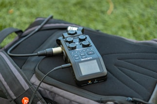 a close up of a cell phone on a backpack