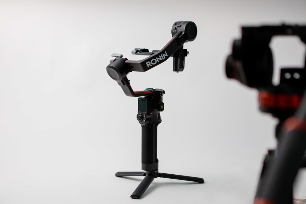 a tripod with a camera attached to it