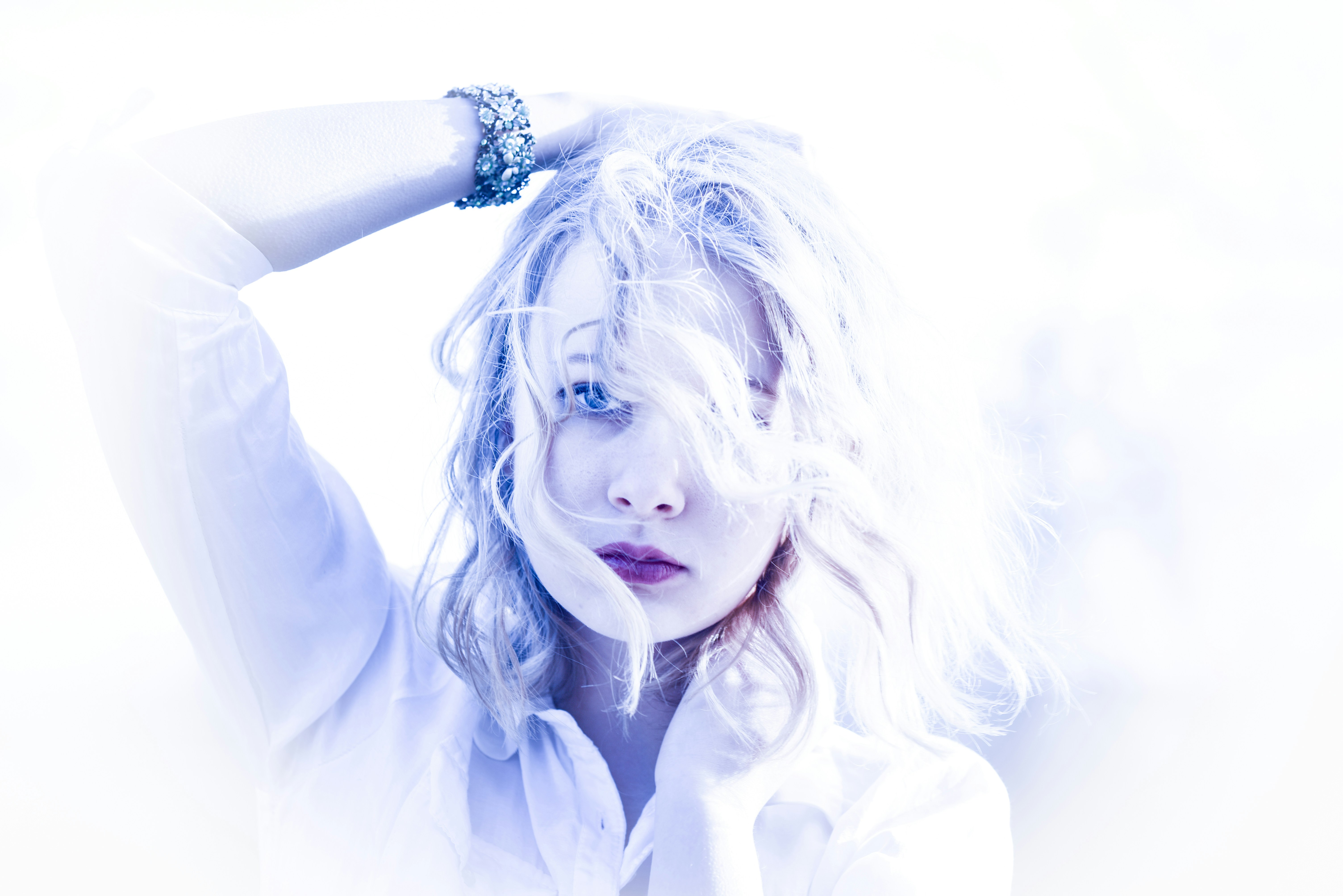 A woman in a white shirt posing for a picture photo – Free Blue Image ...