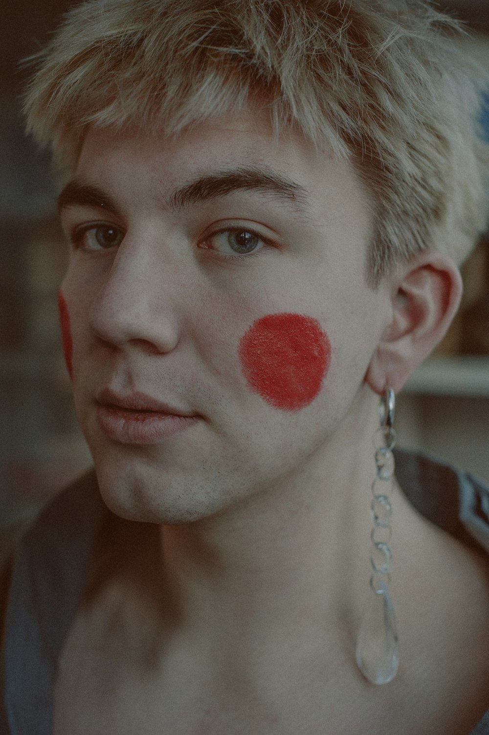 a man with a red spot painted on his face