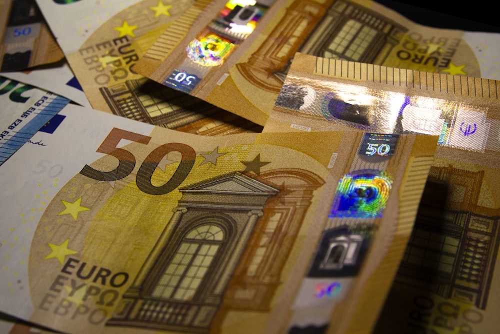a pile of 50 euro bills sitting on top of each other