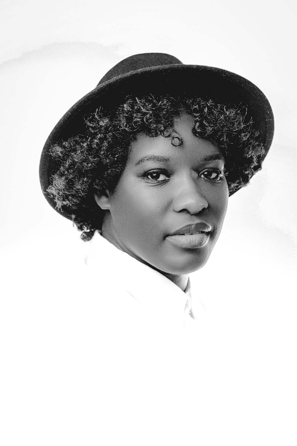 a woman wearing a hat and a white shirt