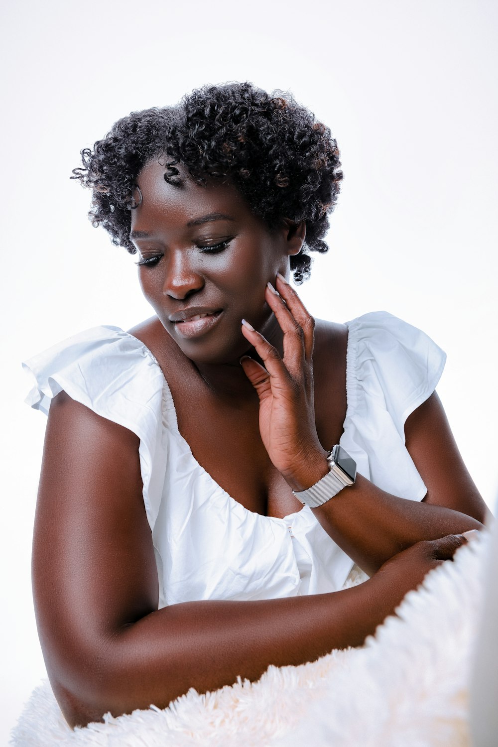 a woman in a white dress sitting down