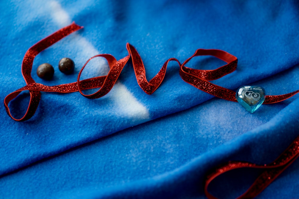 a pair of scissors and a heart on a blue cloth