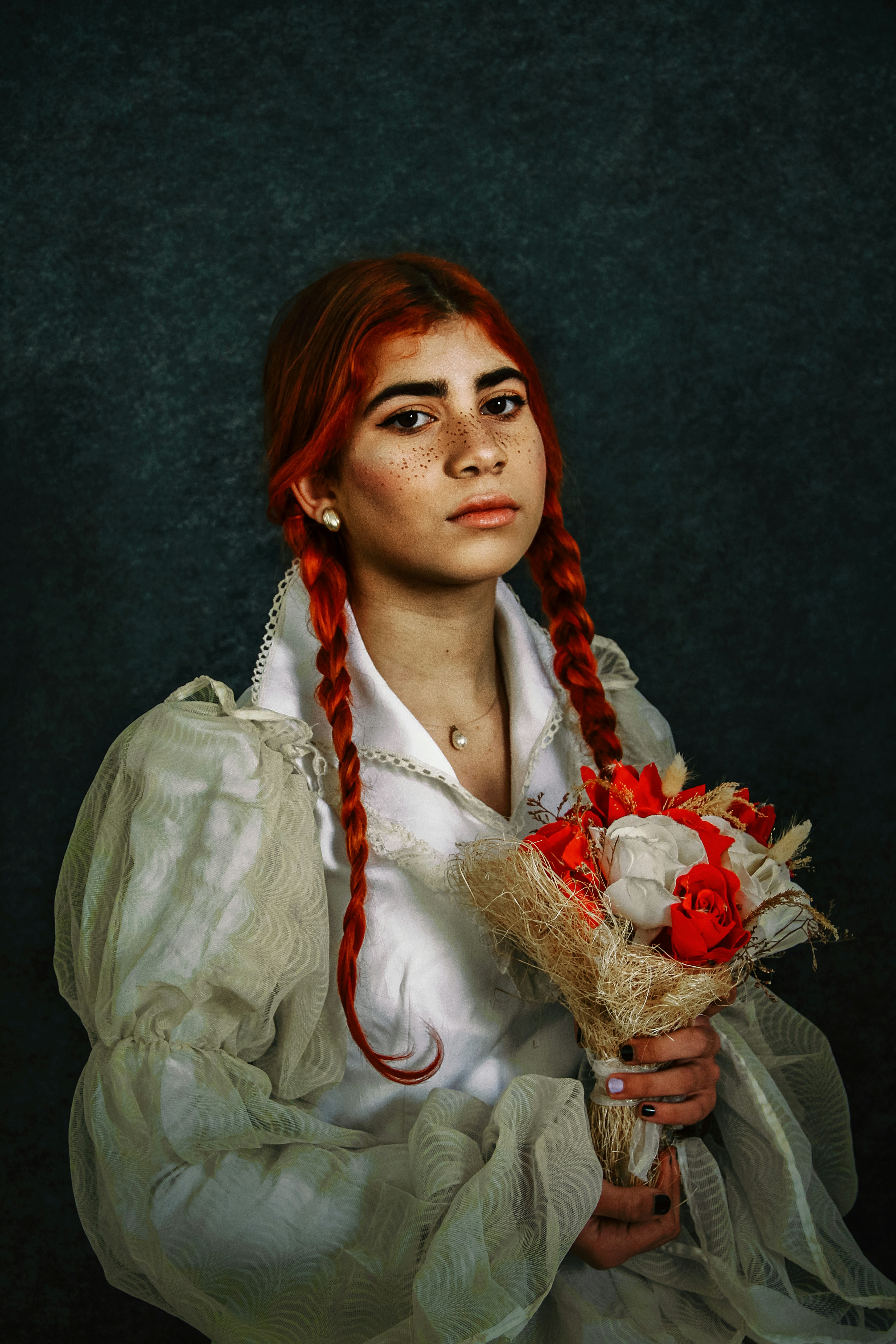 a woman with red hair holding a bouquet of flowers