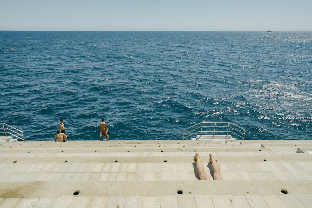 a group of people standing on top of a boat