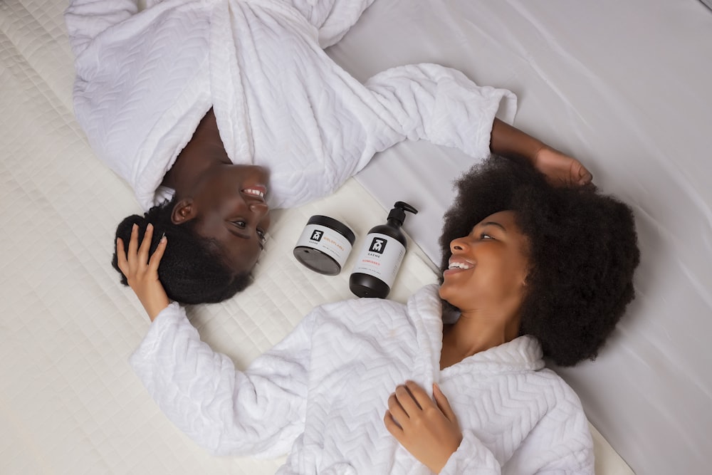 a man and a woman laying on a bed next to each other