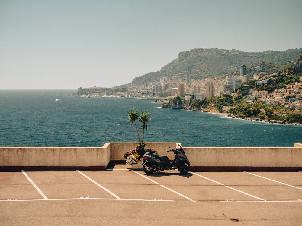 a motorcycle parked on the side of a road next to the ocean
